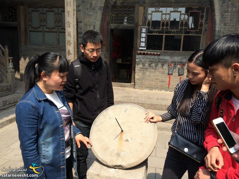  خانه تاریخی وانگ - راهنما در حال توضیح نحوه کارکرد ساعت خورشیدی